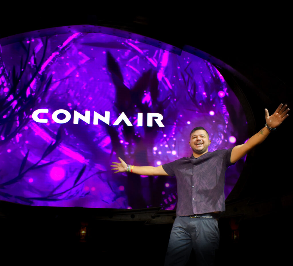 Man smiling in front of a screen