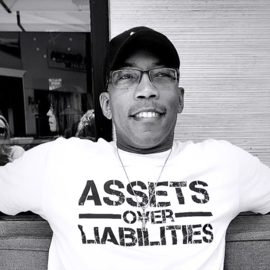 a man sitting on a couch with his arms crossed