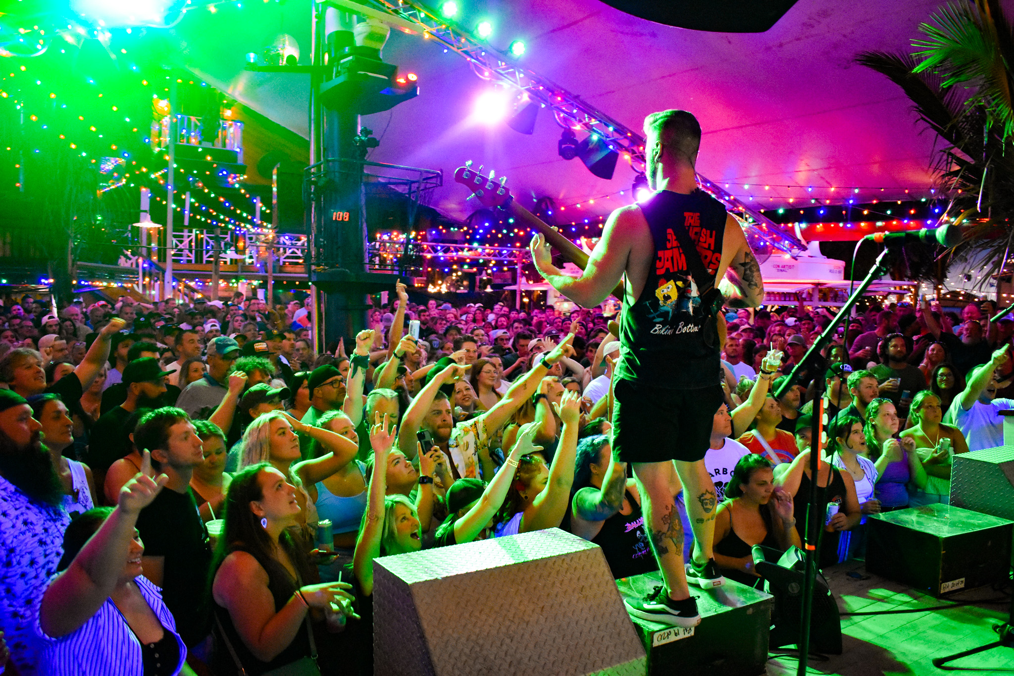 a man standing on top of a stage in front of a crowd