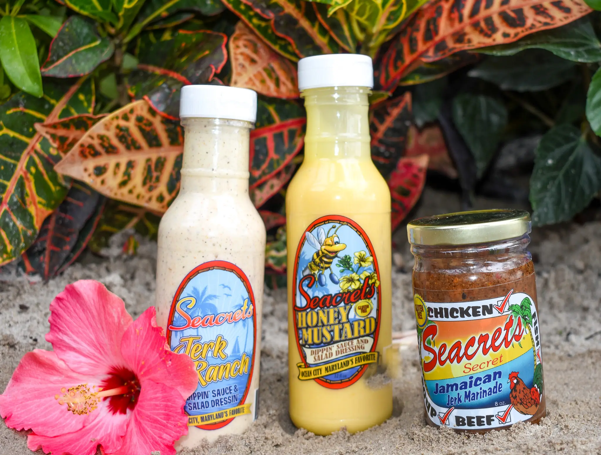 a couple of bottles of food next to a flower